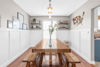 dining room view with wall shelves and ledge for displaying kids artwork