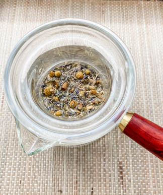 teapot steeping dried chamomile and lavender flower buds 